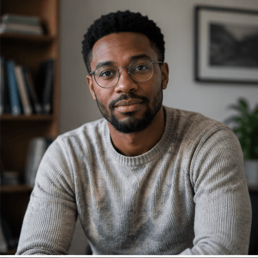 Portrait of a doctoral candidate in glasses and a gray sweater, bookshelves behind.